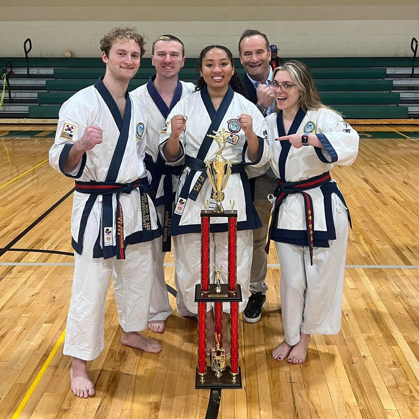 A group of people are practicing martial arts in a gym.