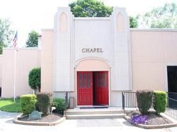 Chapel entrance: red doors, beige facade, 