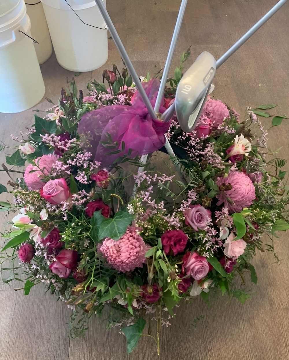 A Wreath of Pink Flowers is Sitting on a Table — Bundaberg House of Flowers In Bargara, QLD