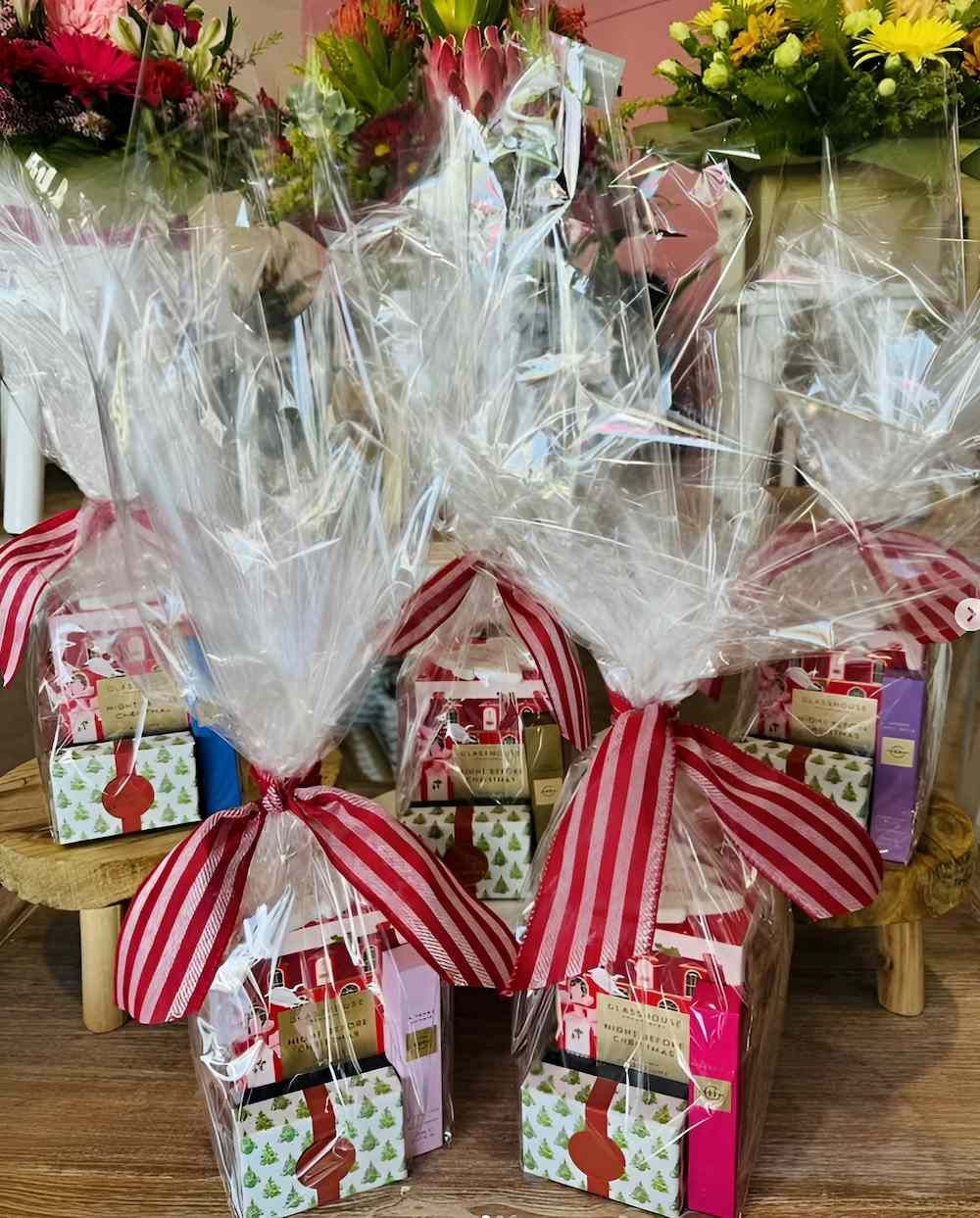 A Bunch of Gifts Wrapped in Plastic and Tied With Ribbons — Bundaberg House of Flowers In Burnett Heads, QLD