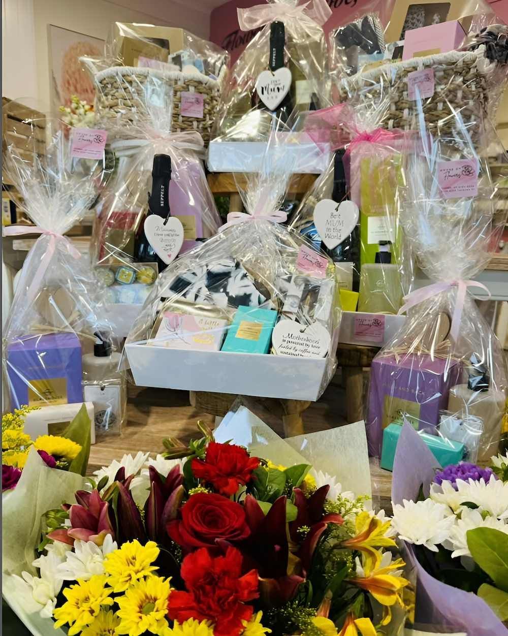 A Bunch of Flowers Are Sitting Next to a Bunch of Gifts Wrapped in Plastic — Bundaberg House of Flowers In Burnett Heads, QLD