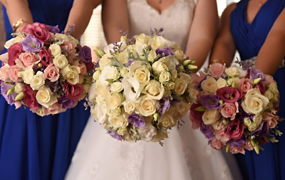 A Bride and Her Bridesmaids Are Holding Bouquets of Flowers in Their Hands — Bundaberg House of Flowers In Bargara, QLD