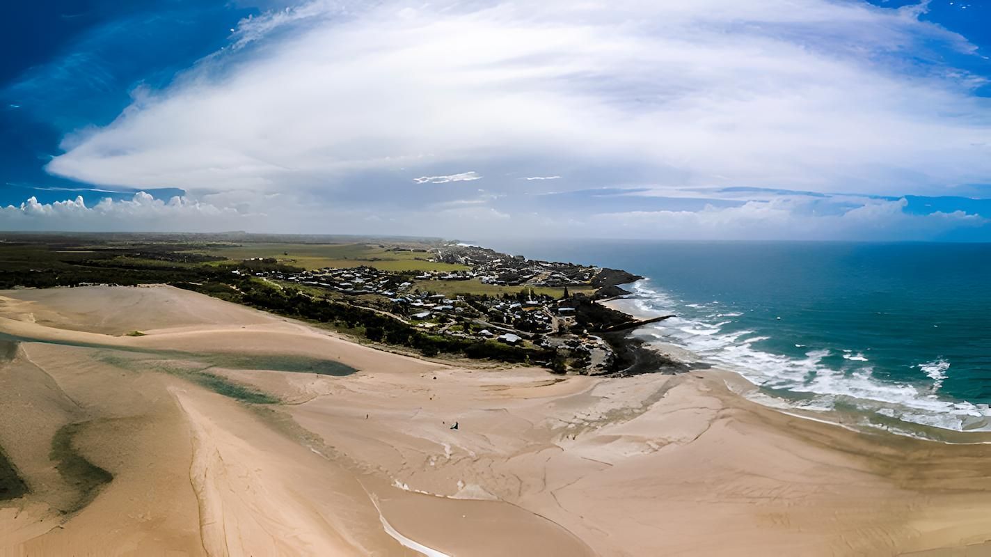 An Aerial View of a Sandy Beach Next to the Ocean — Bundaberg House of Flowers In Elliot Heads, QLD