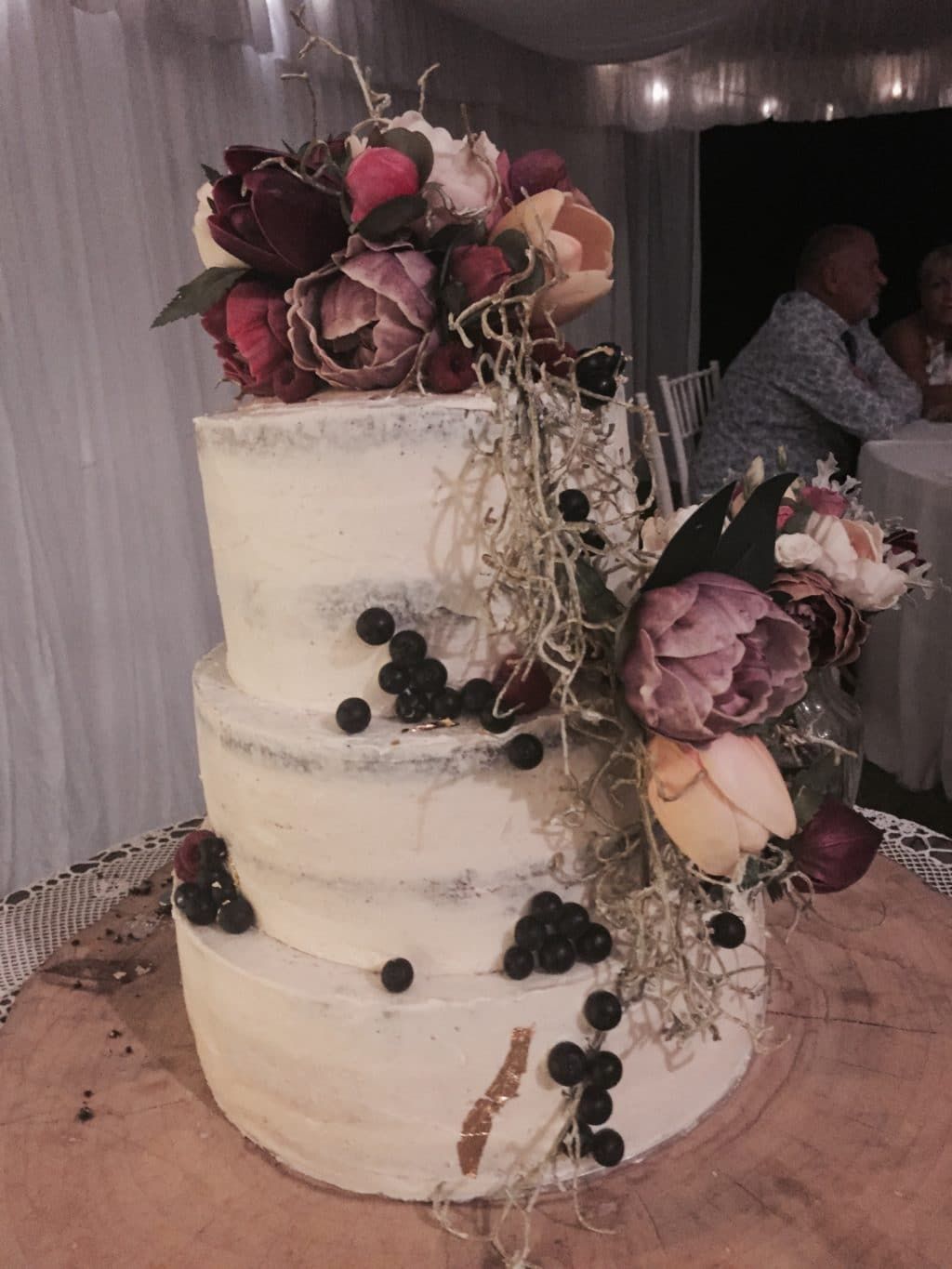 A Wedding Cake with Flowers and Blueberries on It — Bundaberg House of Flowers in Bundaberg West, QLD