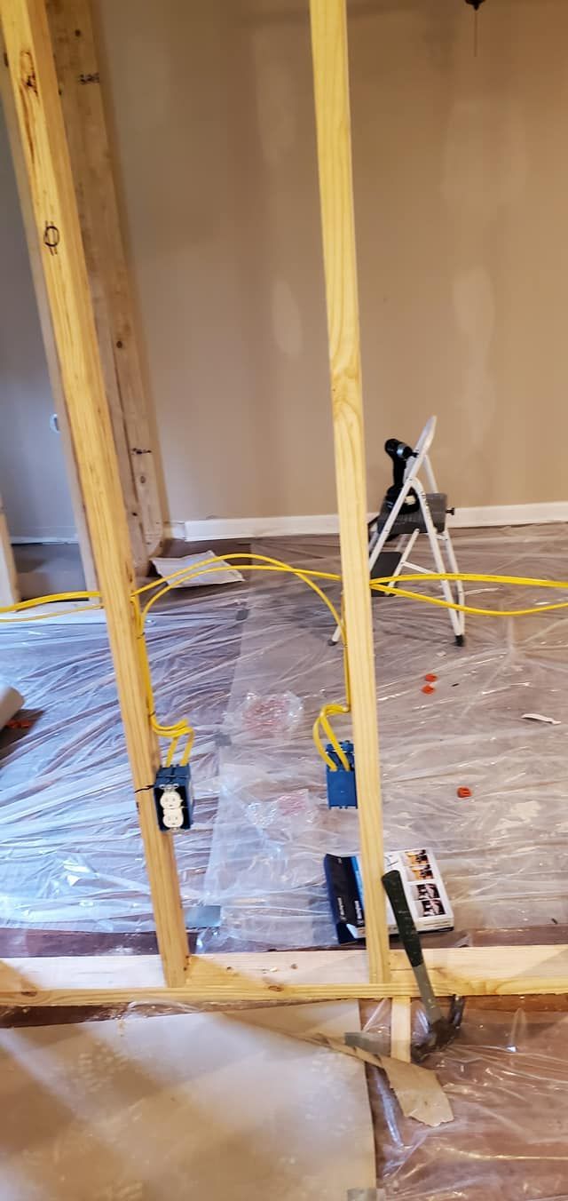 A room is being remodeled and covered in plastic.