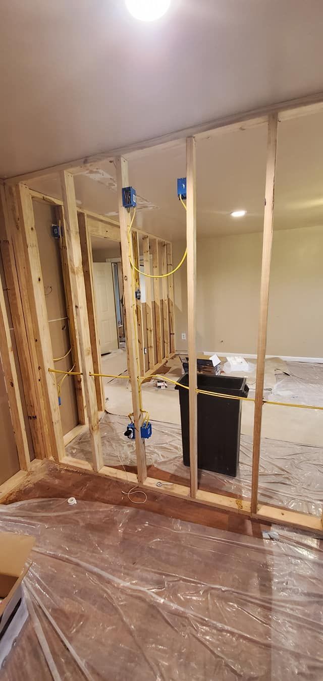 A room with a lot of wooden walls and a trash can in it.