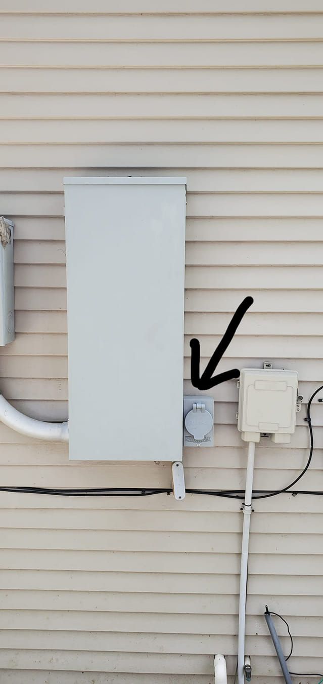 A white box on the side of a house with a black arrow pointing to it.