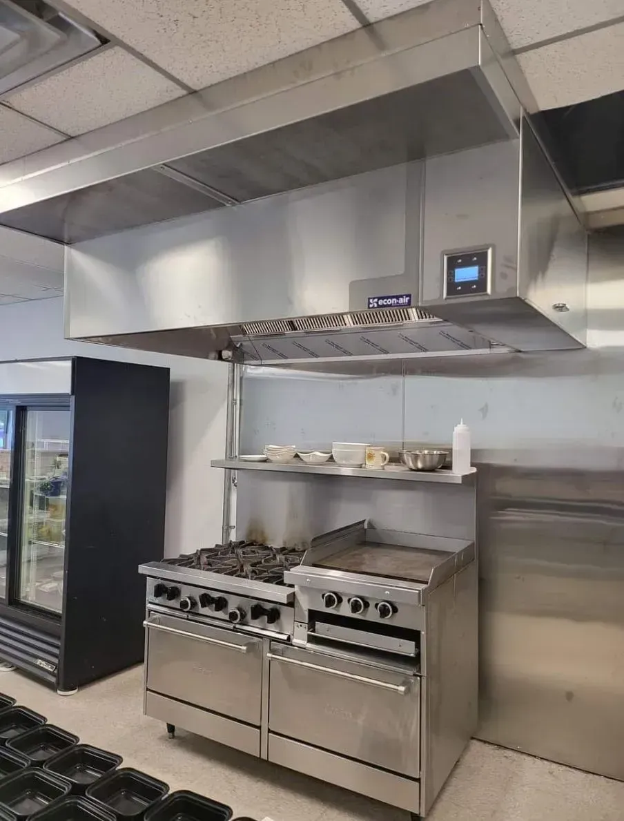 A kitchen with a stove and a refrigerator in it