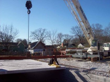 a Wilson crane holding a steel girder