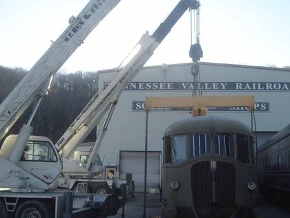 a Wilson crane lifting an old train car