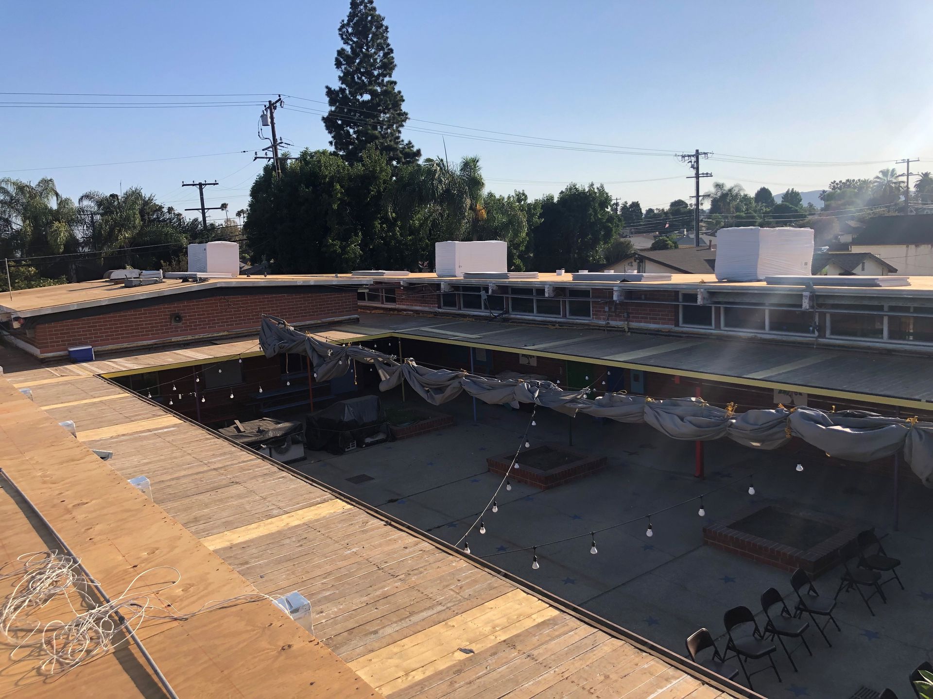 A large building with a roof that is being remodeled