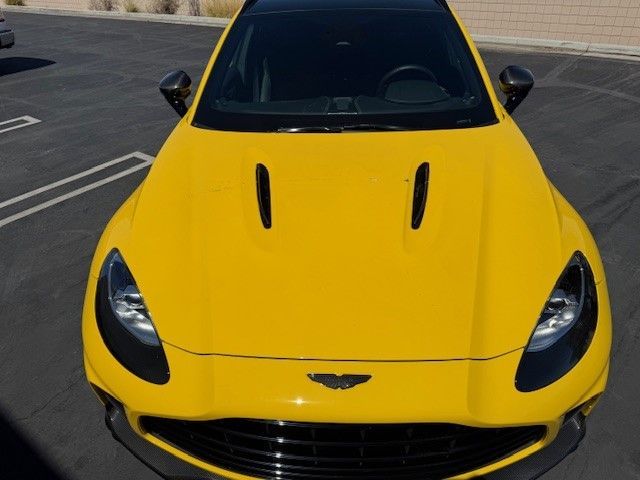 A yellow sports car is parked in a parking lot.