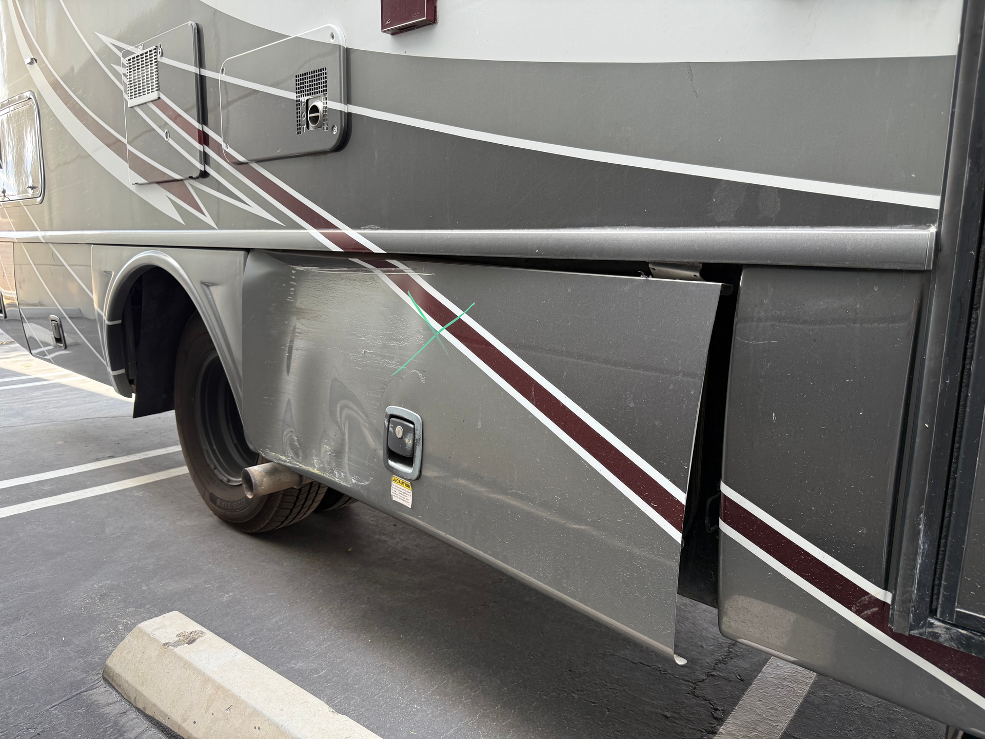 A car is sitting on a lift in a garage.