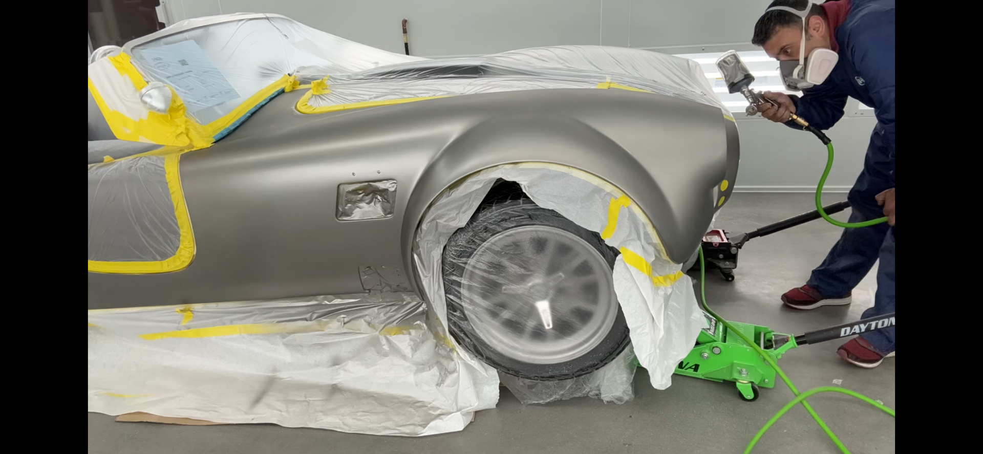 A wall with a lot of different colors of paint on it.