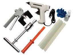 Tools for paintless dent repair, including a glue gun, puller, and glue sticks.