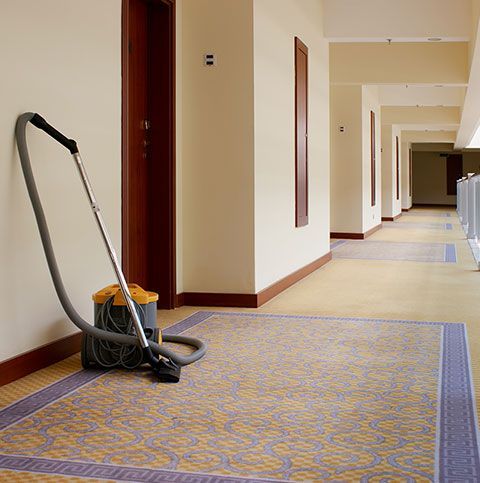 Person using a clean cloth to mop and polish a floor until it gleams with cleanliness.