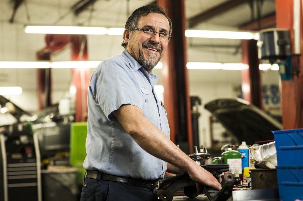 Mechanic Working on a Car Engine | Acute Auto Care LLC