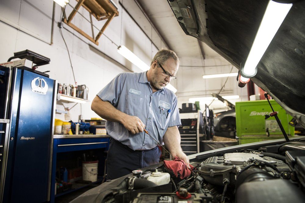 Mechanic Working on a Vehicle | Acute Auto Care LLC