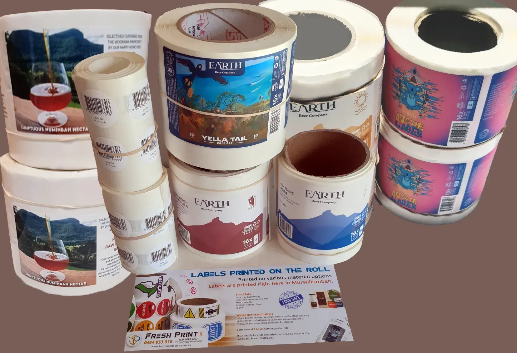 Assorted Colorful Custom-printed Tape Rolls and Labels Displayed on a Tabletop — Fresh Print Signs In South Murwillumbah, NSW