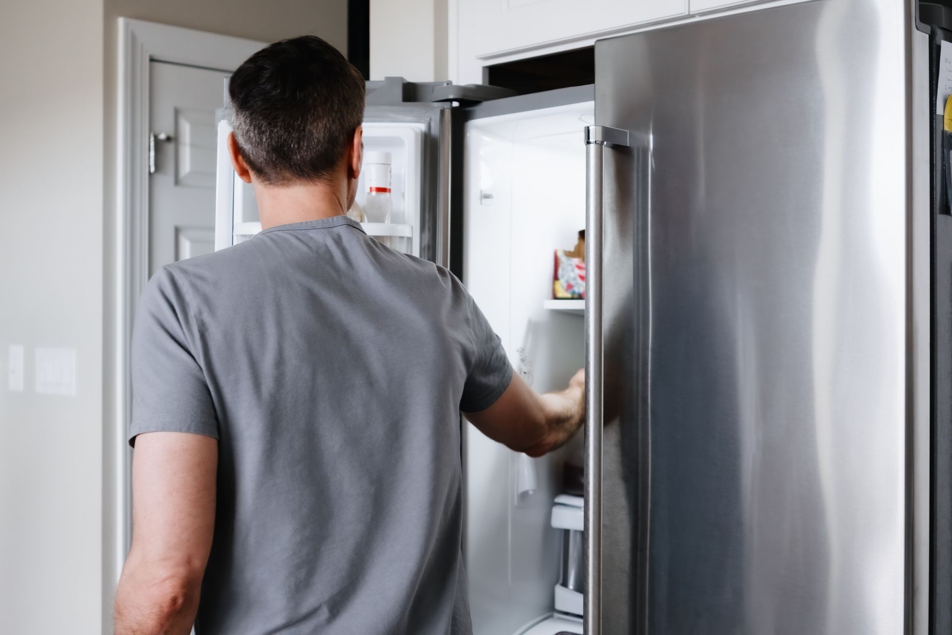 Man Fixing Refrigerator — Corona, CA — Tru-Way Appliance Parts & Service