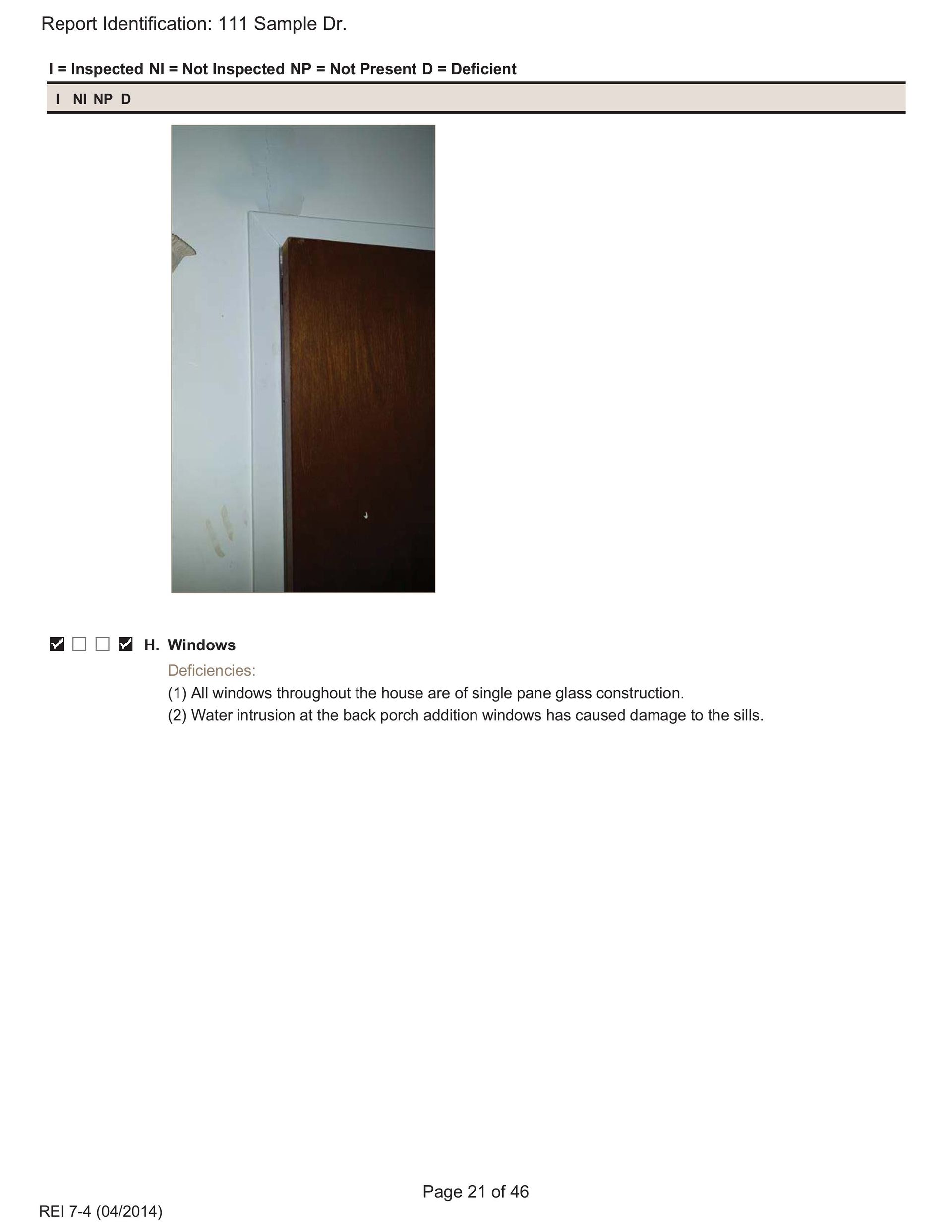 Close-up of a brown door frame with peeling white paint and cracks on the adjacent wall.