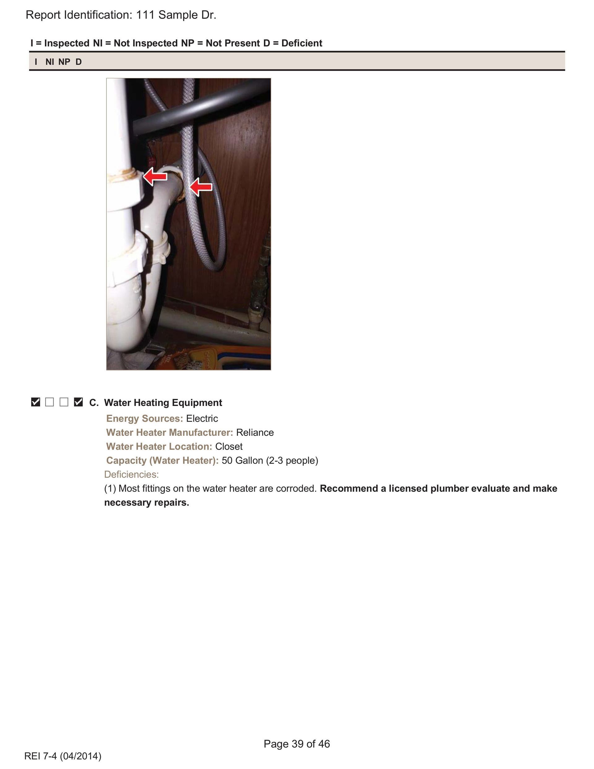 A white pipe under a sink with two red arrows pointing to a leak at a pipe joint connection.