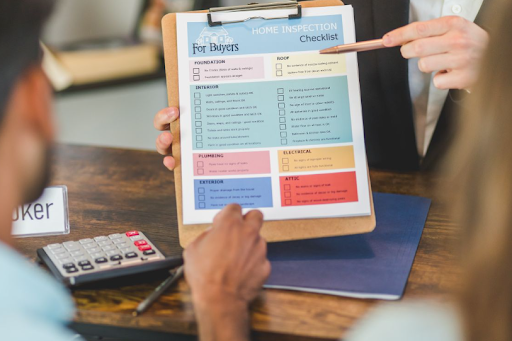Person reviewing a colorful checklist on a clipboard at a desk