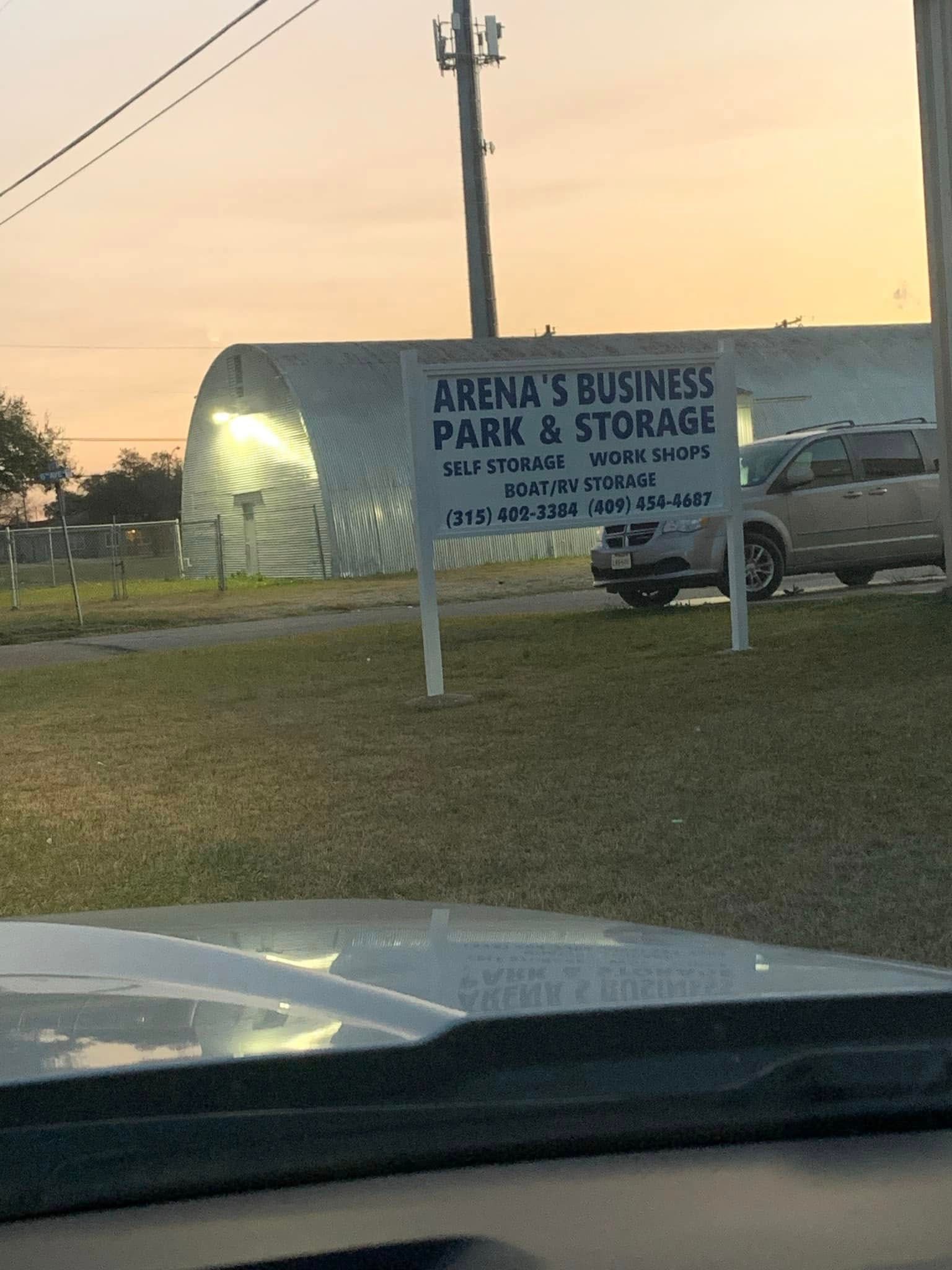 A sign for arena 's business park and storage is in front of a building.