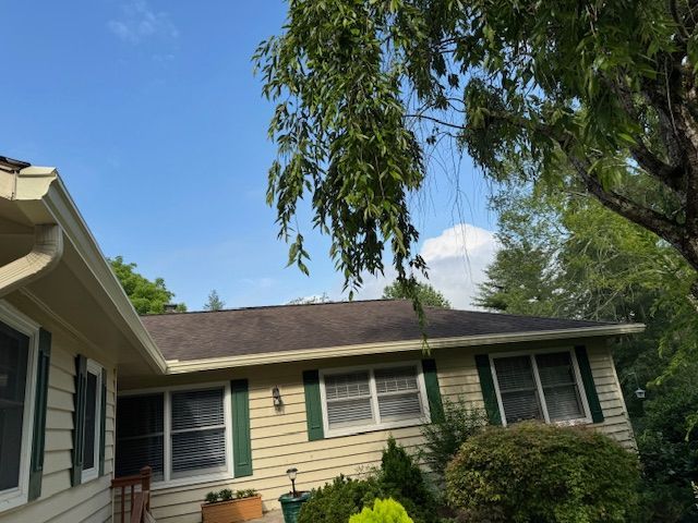 A porch with gutter from the roof of a house.