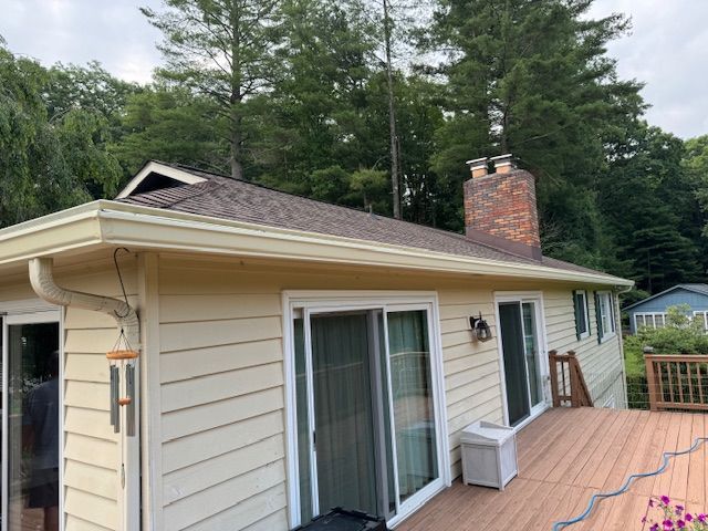 A porch with gutter from the roof of a house.