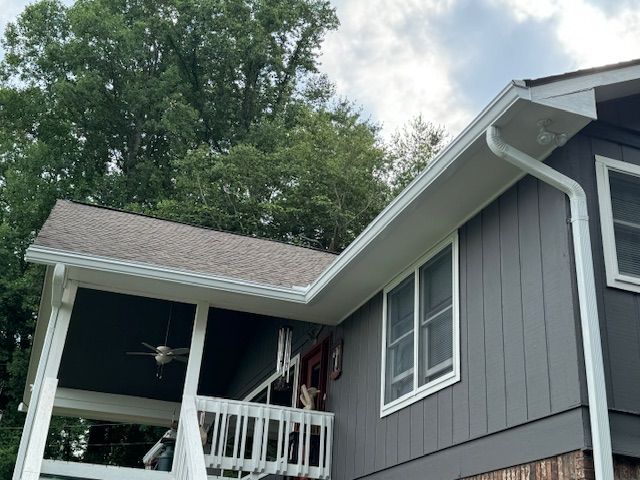 A porch with gutter from the roof of a house.