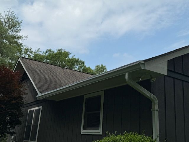 A porch with gutter from the roof of a house.