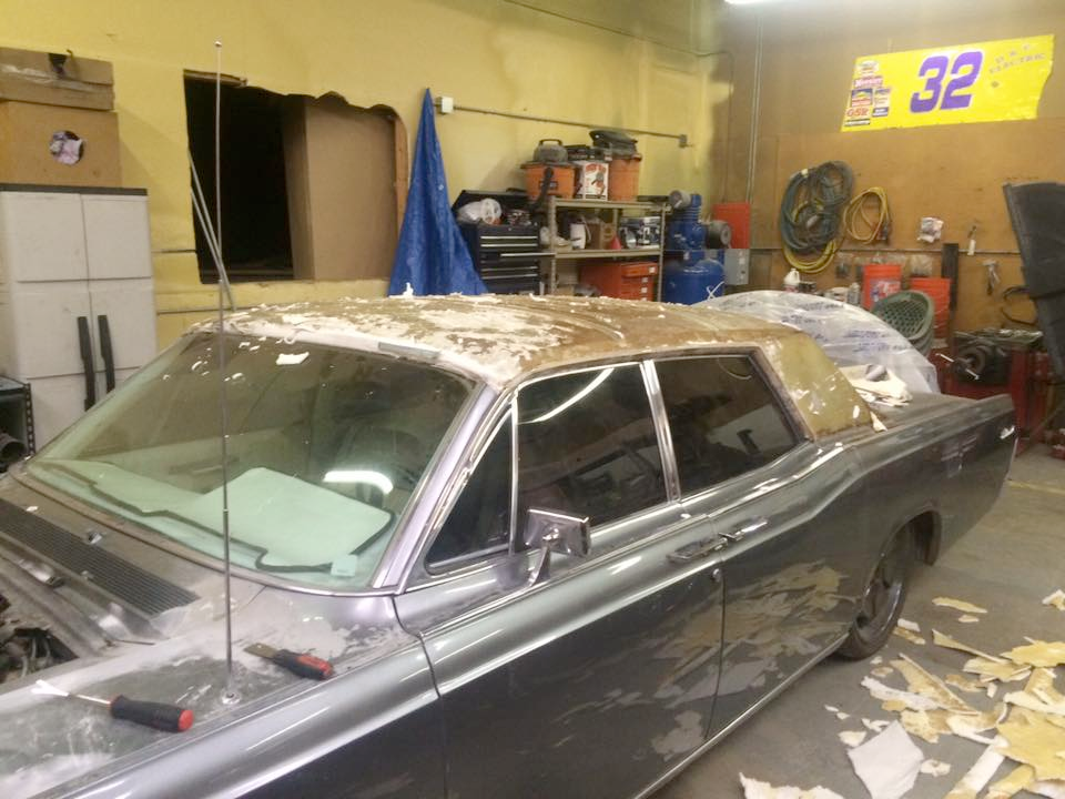 A car in a garage with a sign that says 32 on it