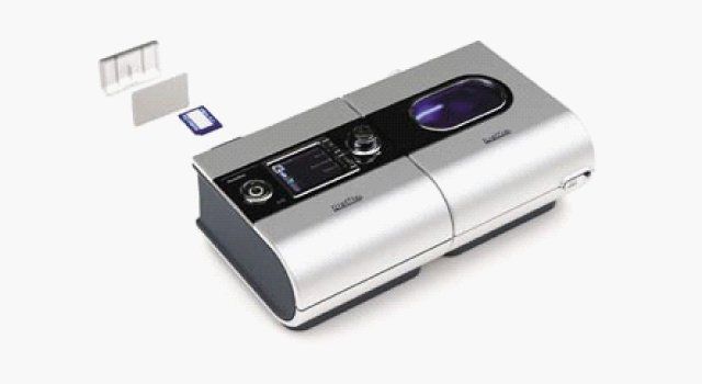 Silver CPAP machine with filters, used for sleep apnea treatment.