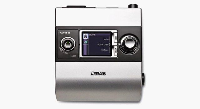 CPAP machine with digital display and control knobs.