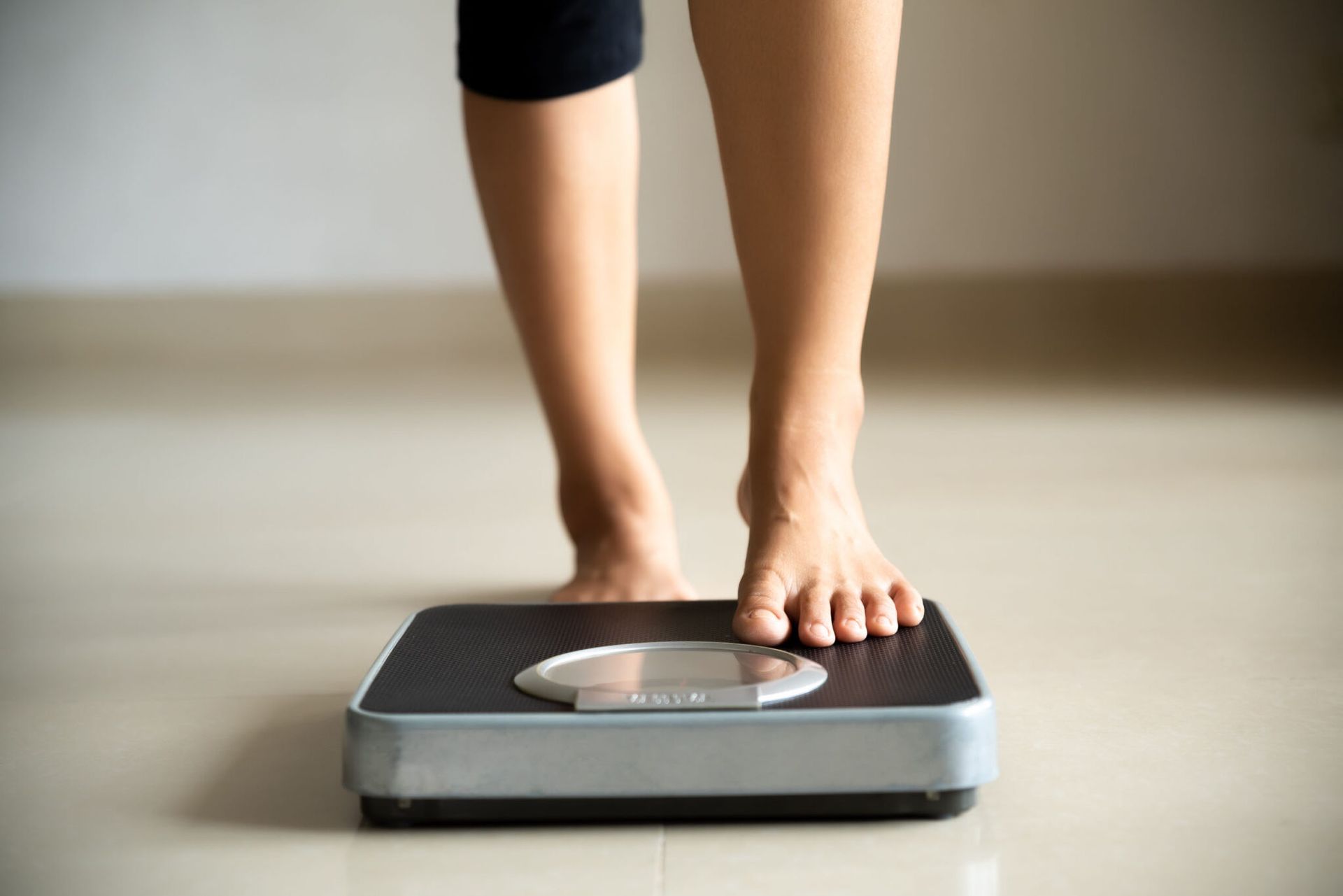 A woman is standing on a scale.