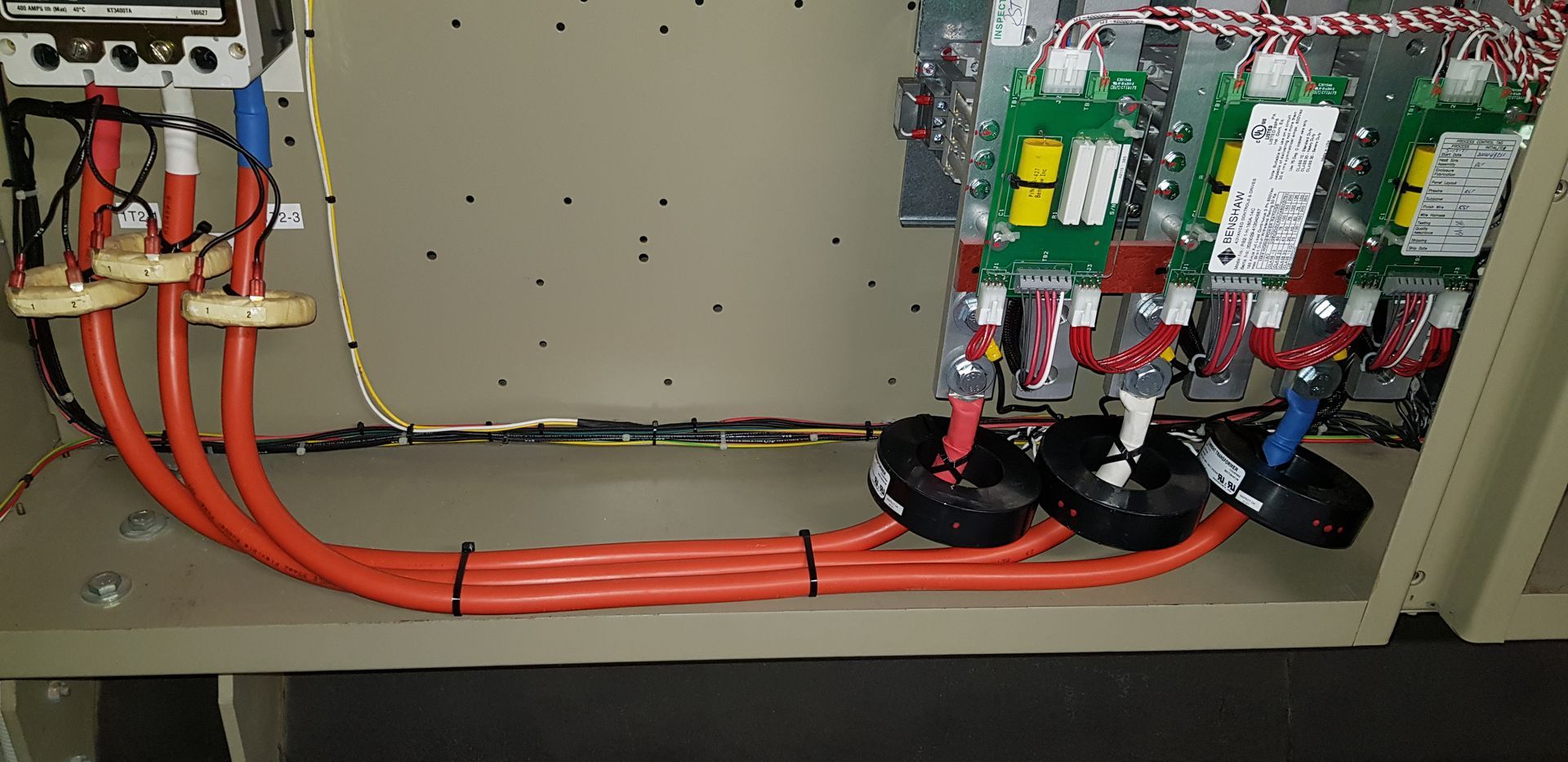 A close up of a electrical box with a bunch of wires coming out of it.