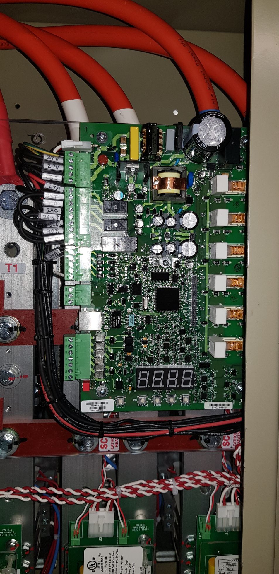 A close up of a motherboard with a lot of wires coming out of it.