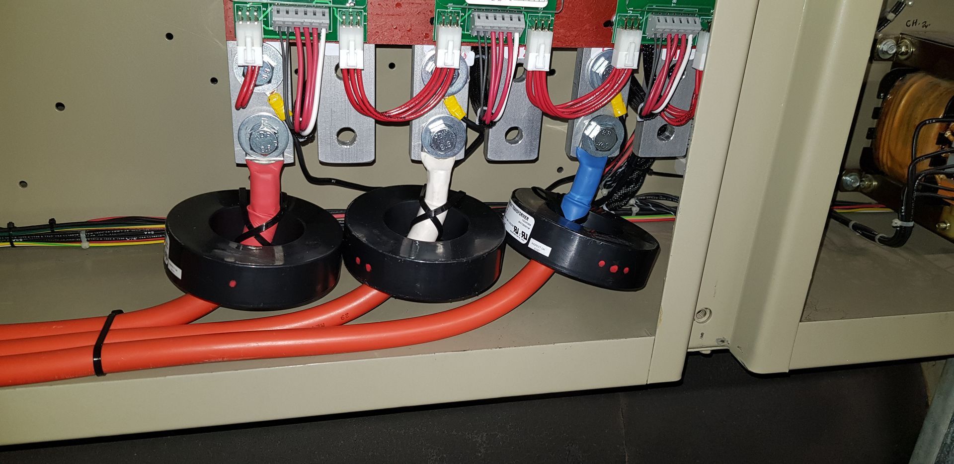 A close up of a electrical box with a bunch of wires coming out of it.