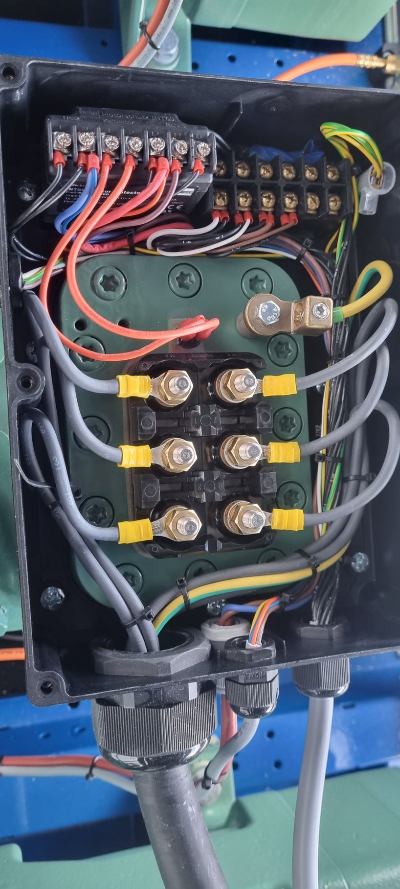 A close up of a electrical box with wires coming out of it.
