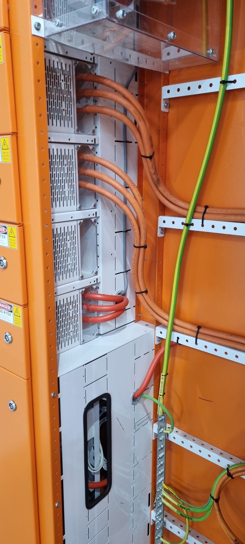 A bunch of wires are hanging from a wall in a room.