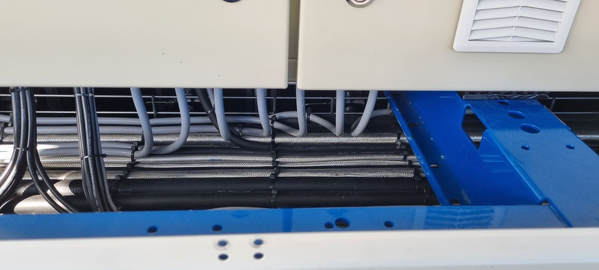 A close up of a electrical box with wires coming out of it.