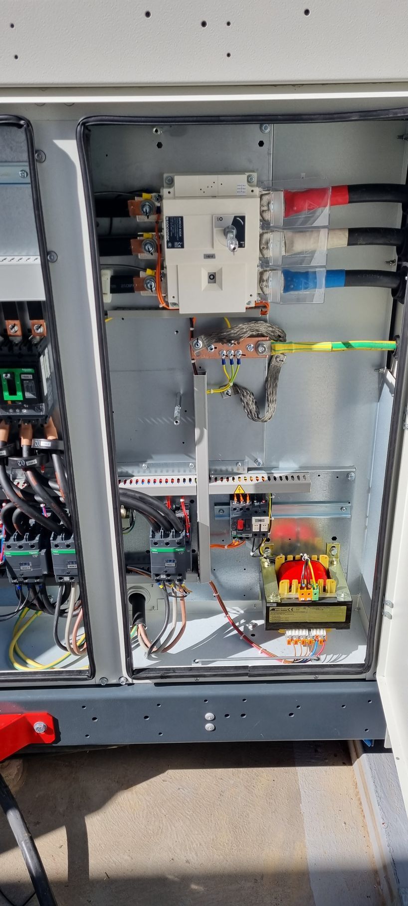 The inside of a electrical box with a lot of wires coming out of it.