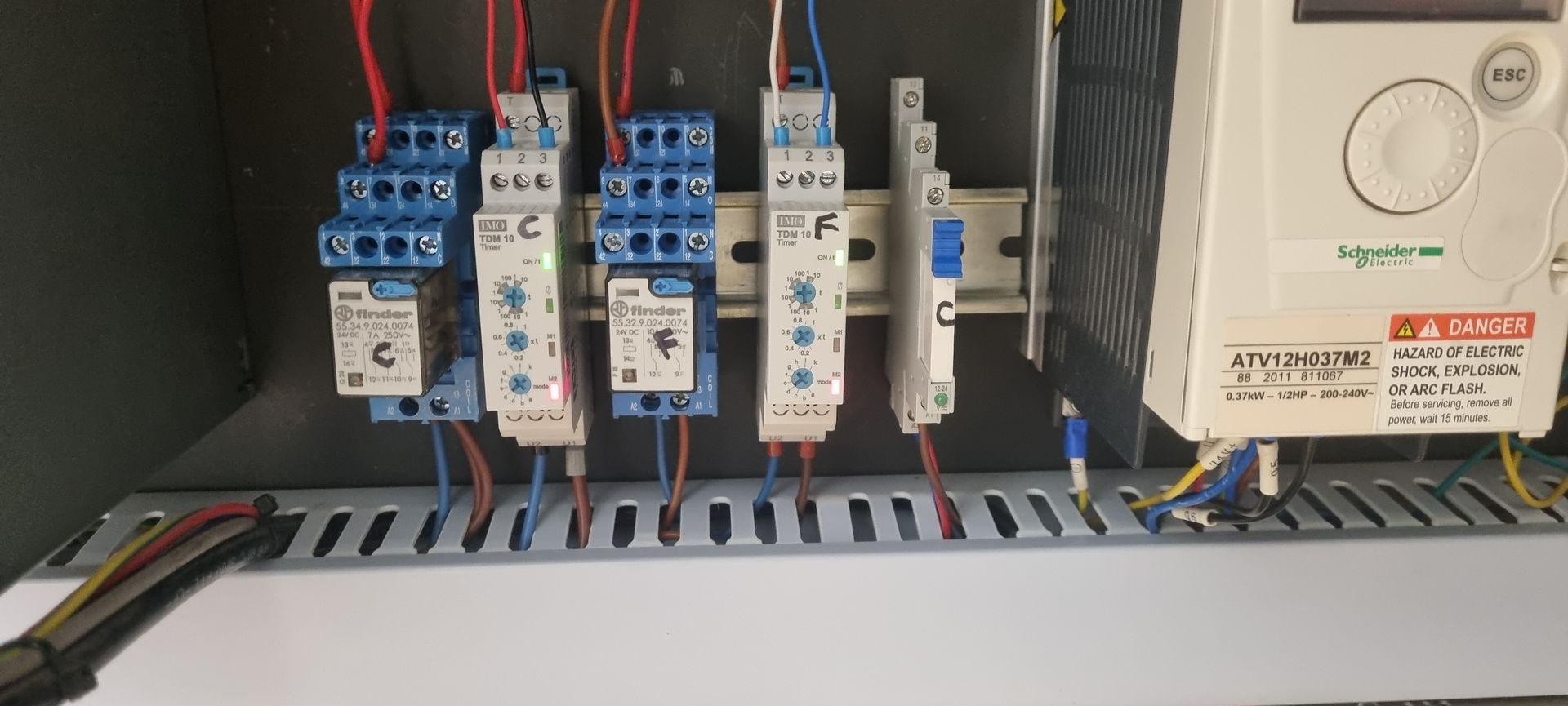 A close up of a electrical panel with a lot of wires connected to it.