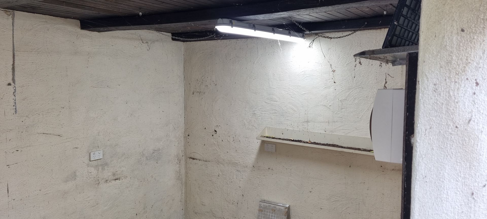 An empty room with a light on the ceiling.