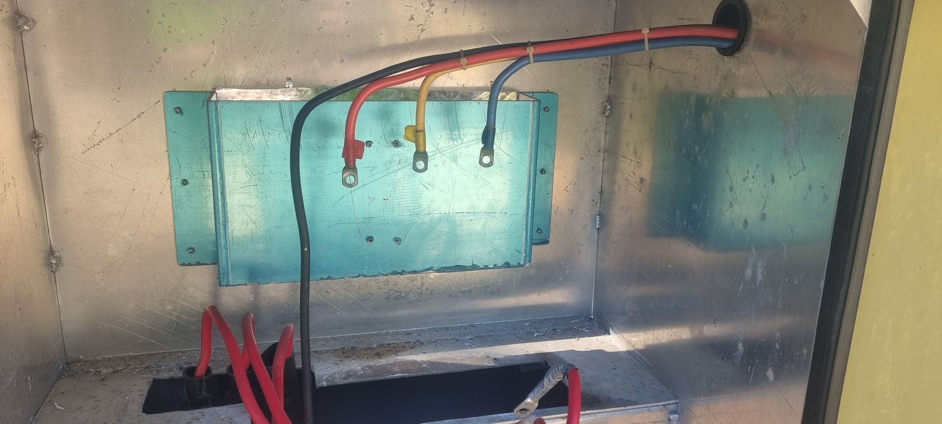 A close up of a box with wires coming out of it.