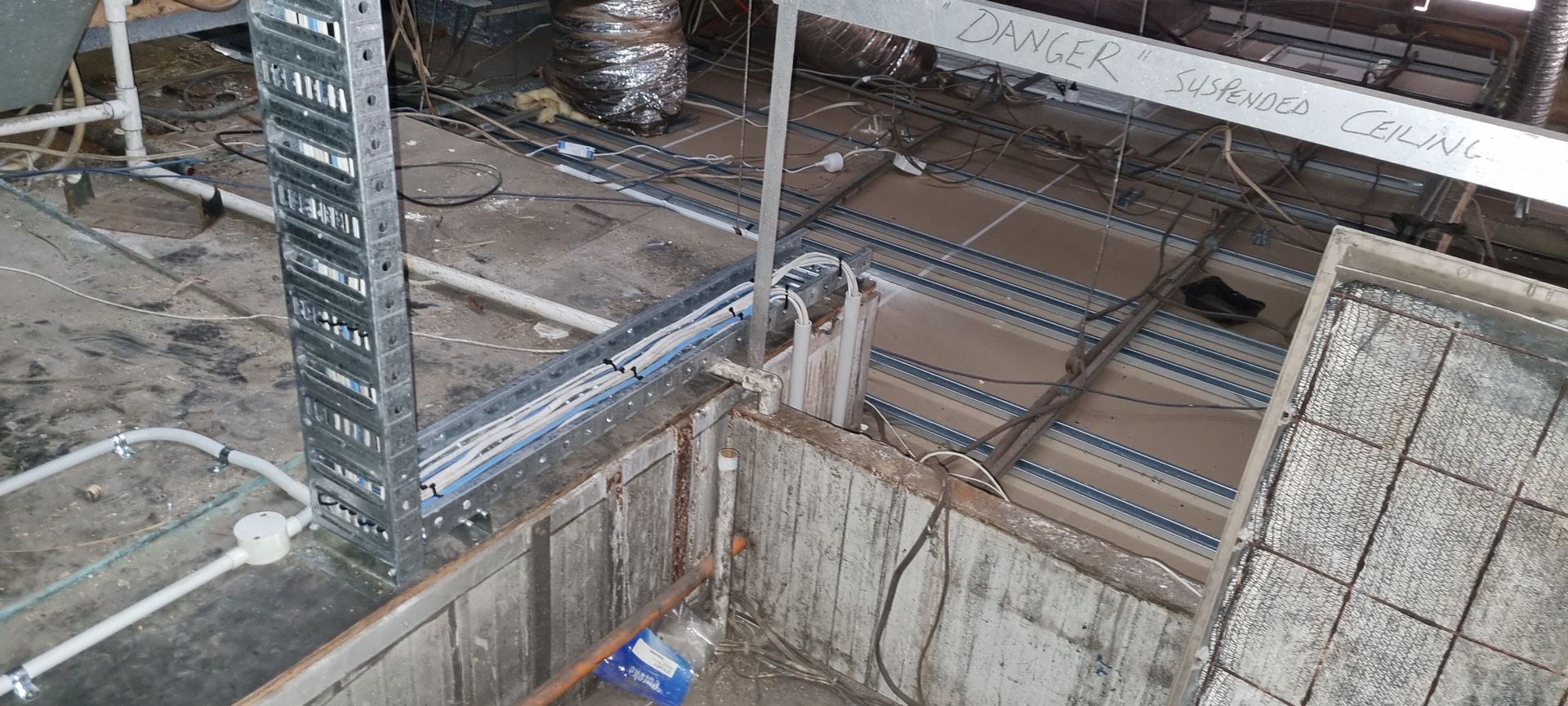 A building under construction with a lot of wires coming out of it.