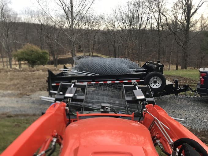 An orange tractor with a trailer attached to it