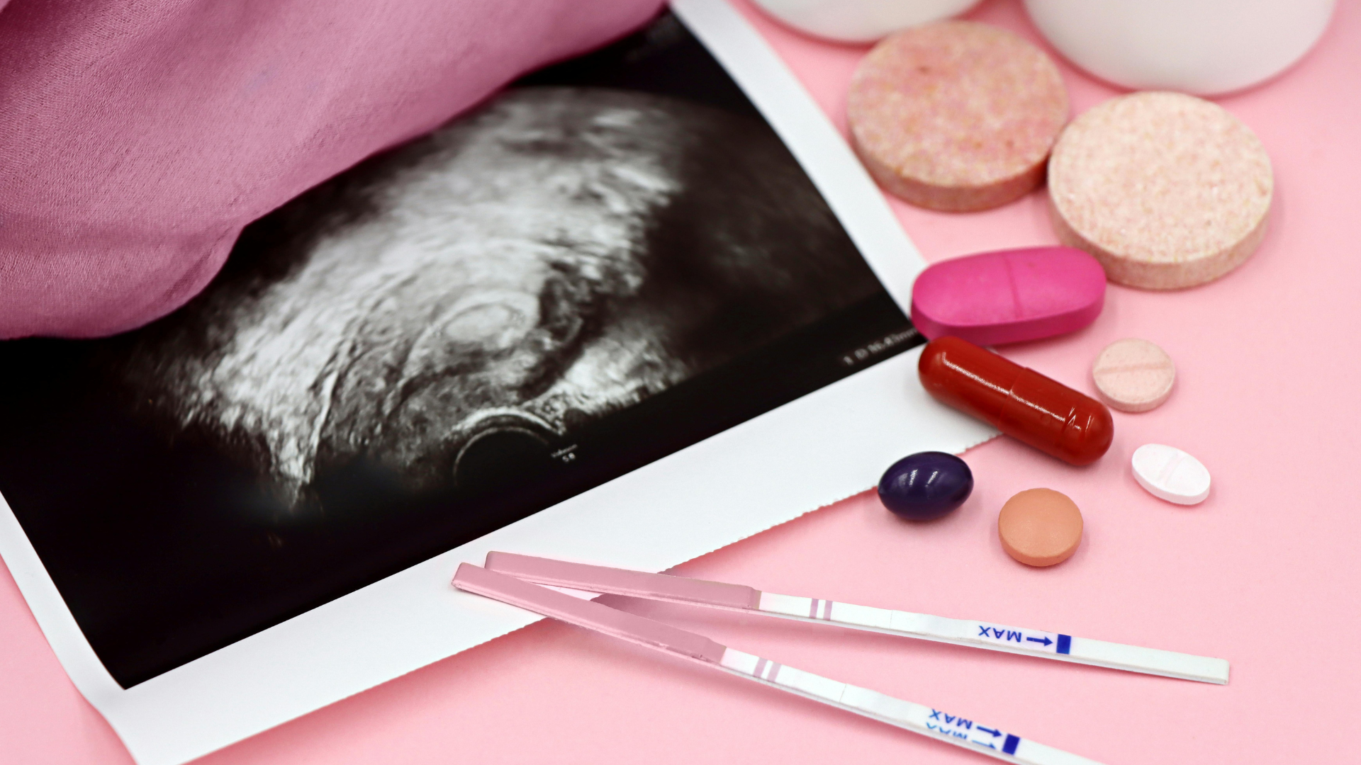 Assortment of culinary herbs and spices arranged in a circle, including cinnamon, ginger, turmeric, and rosemary, with a mortar and pestle.