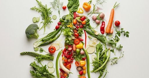 Silhouette of a human body made of various colorful fruits and vegetables on a white background.